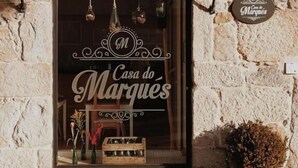 A stone building with a large window displaying 'Casa do Marques' sign. - Casa do Marqués (Baiona)