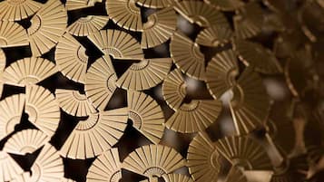 A close-up of a patterned metallic surface with a repeating design.