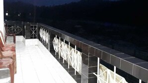A balcony with a tiled floor and a railing with geometric patterns. - The Park Hotel (Kurseong)
