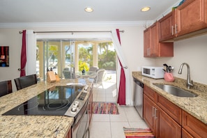 Deluxe Condo, Patio, Lagoon View | Private kitchen | Fridge, microwave, oven, stovetop - Island House #12 by Cayman Vacation (North Side)