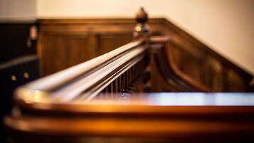 A close-up of a wooden staircase railing.