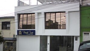 A modern building with a sign reading "Bayit Tov" and large windows.