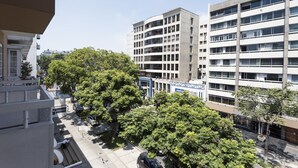 A multi-story building with a modern architectural design, featuring a mix of balconies and large windows. - InkaHuset Miraflores (Lima)