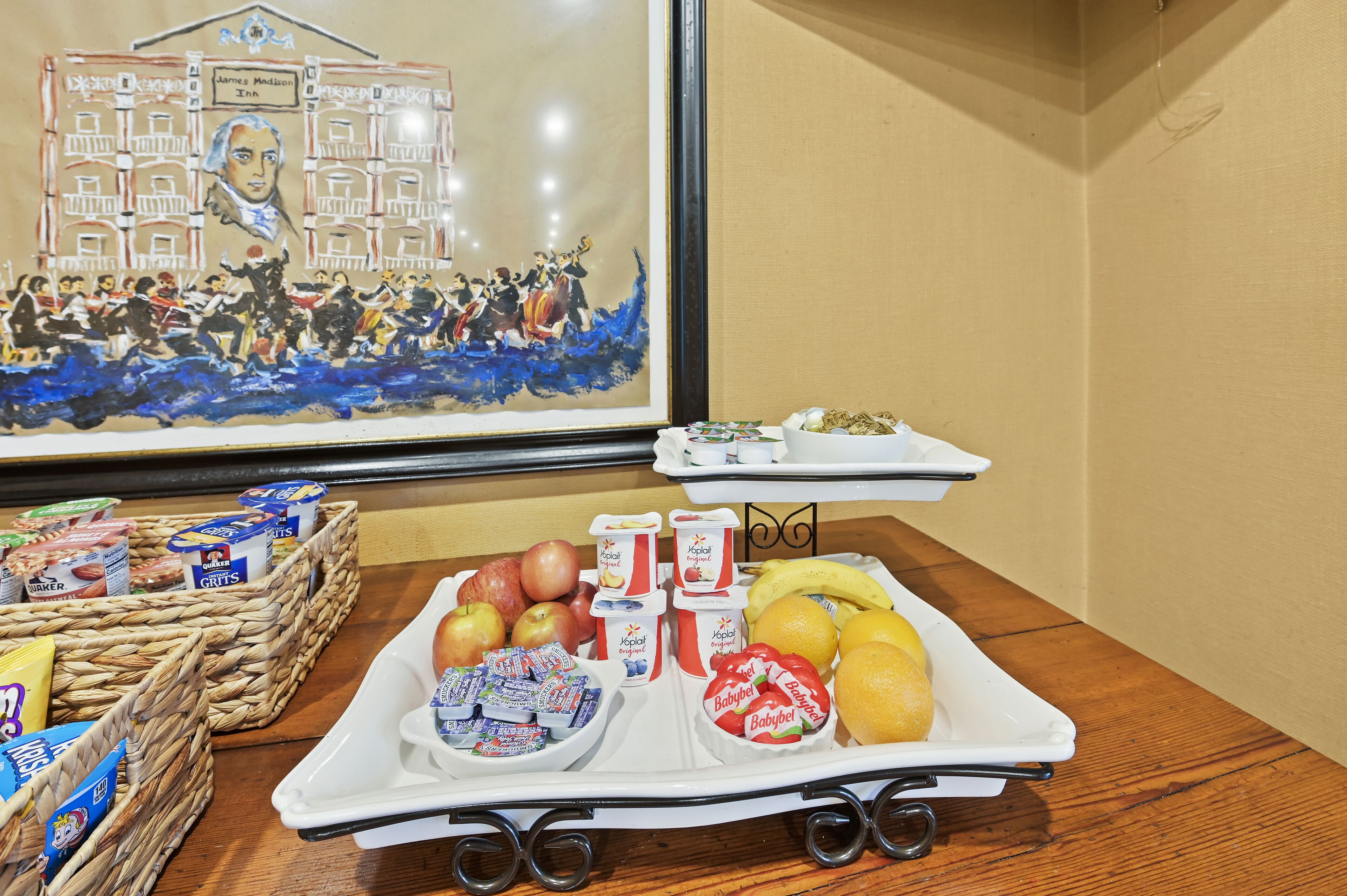 A breakfast buffet with fruits, yogurt, and cereal.