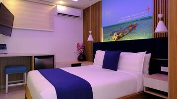 Ein modernes Hotelzimmer mit Bett, Nachttischen, einem Schreibtisch und einem an der Wand befestigten Fernseher.