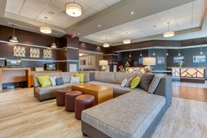 A spacious lobby with a large sectional sofa, a reception desk, and a modern chandelier. - Drury Inn & Suites Cincinnati Northeast Mason (Mason)