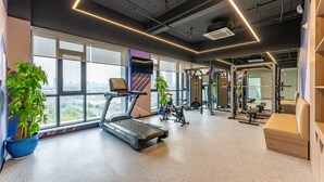 A modern gym with a treadmill, stationary bike, and various exercise equipment. - Holiday Inn Express Hefei Ftz by IHG (Hefei)