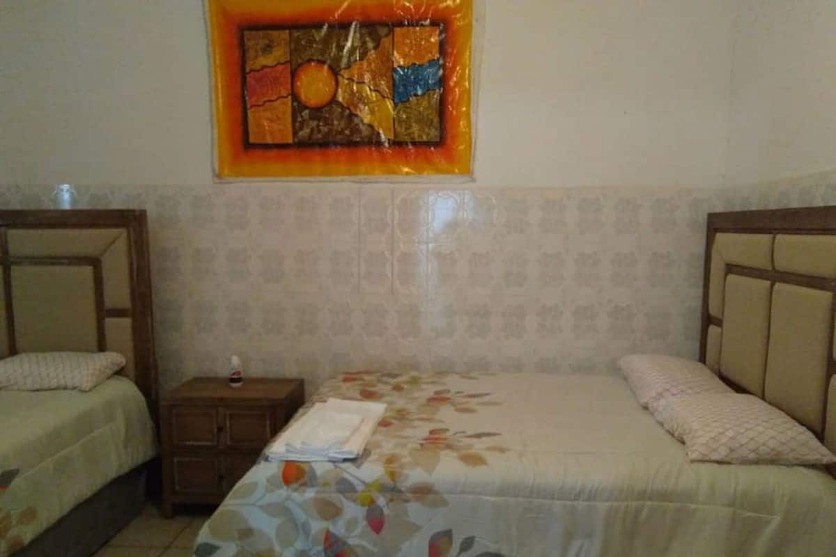 Triple Room, Non Smoking | Blackout drapes, iron/ironing board (on request), bed sheets