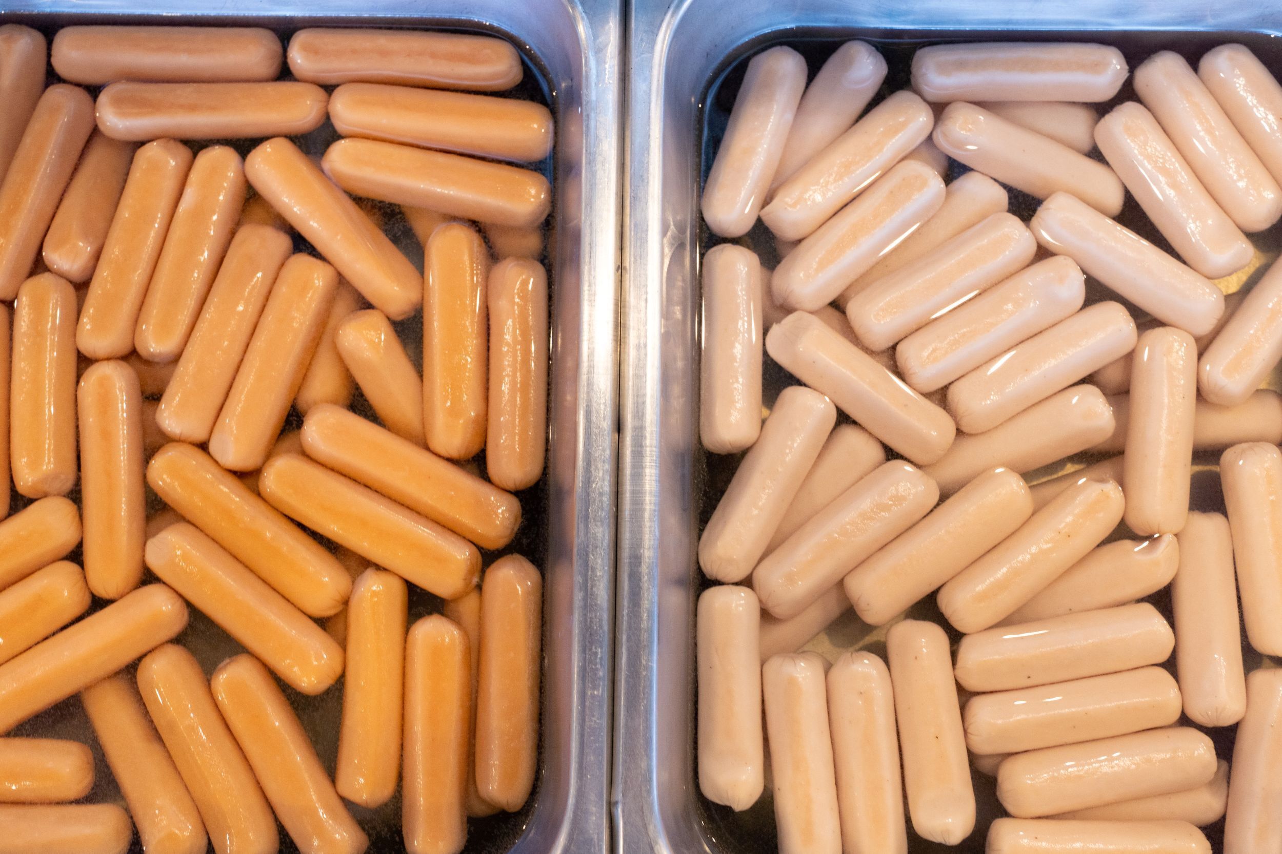 Two containers of hot dogs.