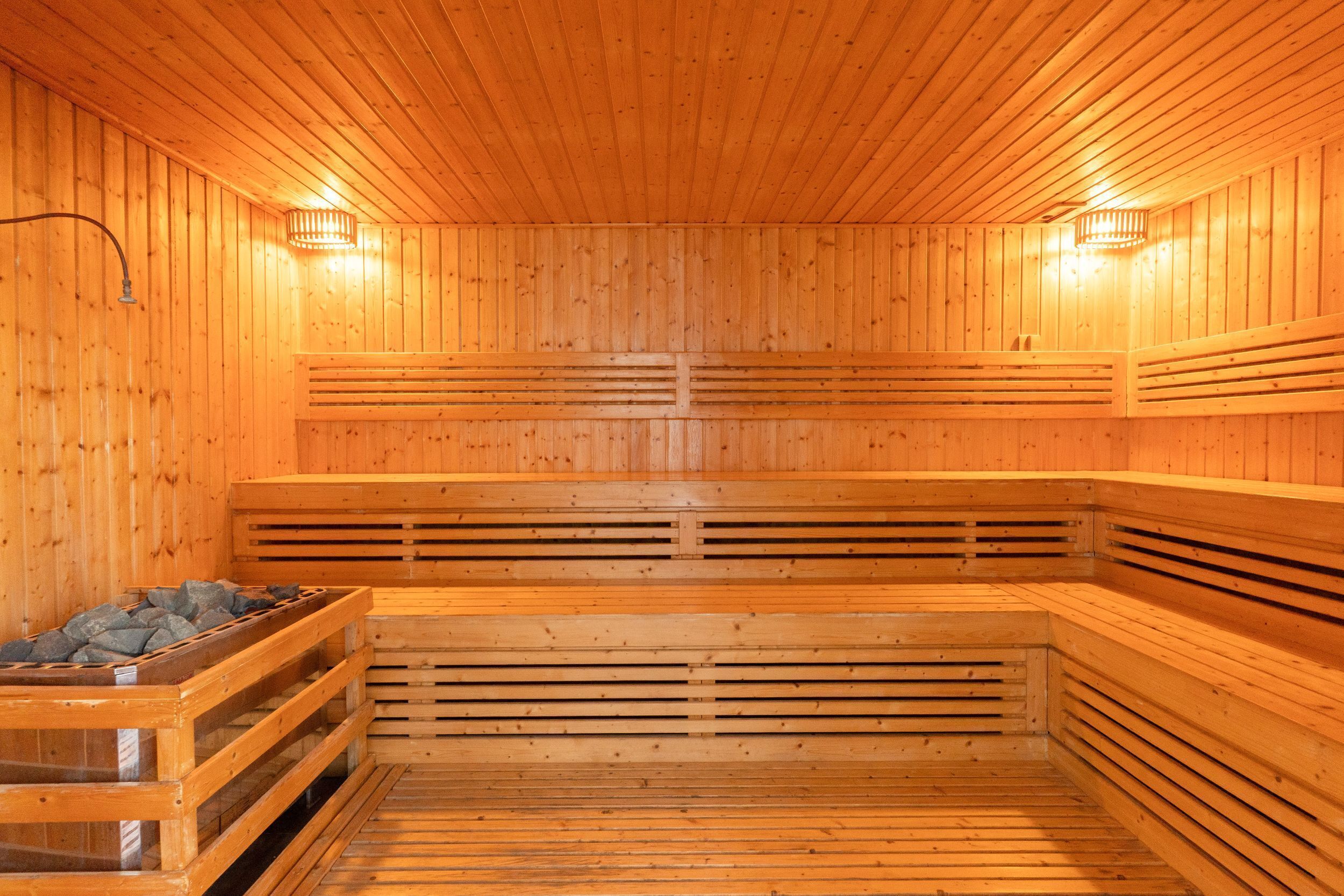 A sauna with wooden walls and benches.