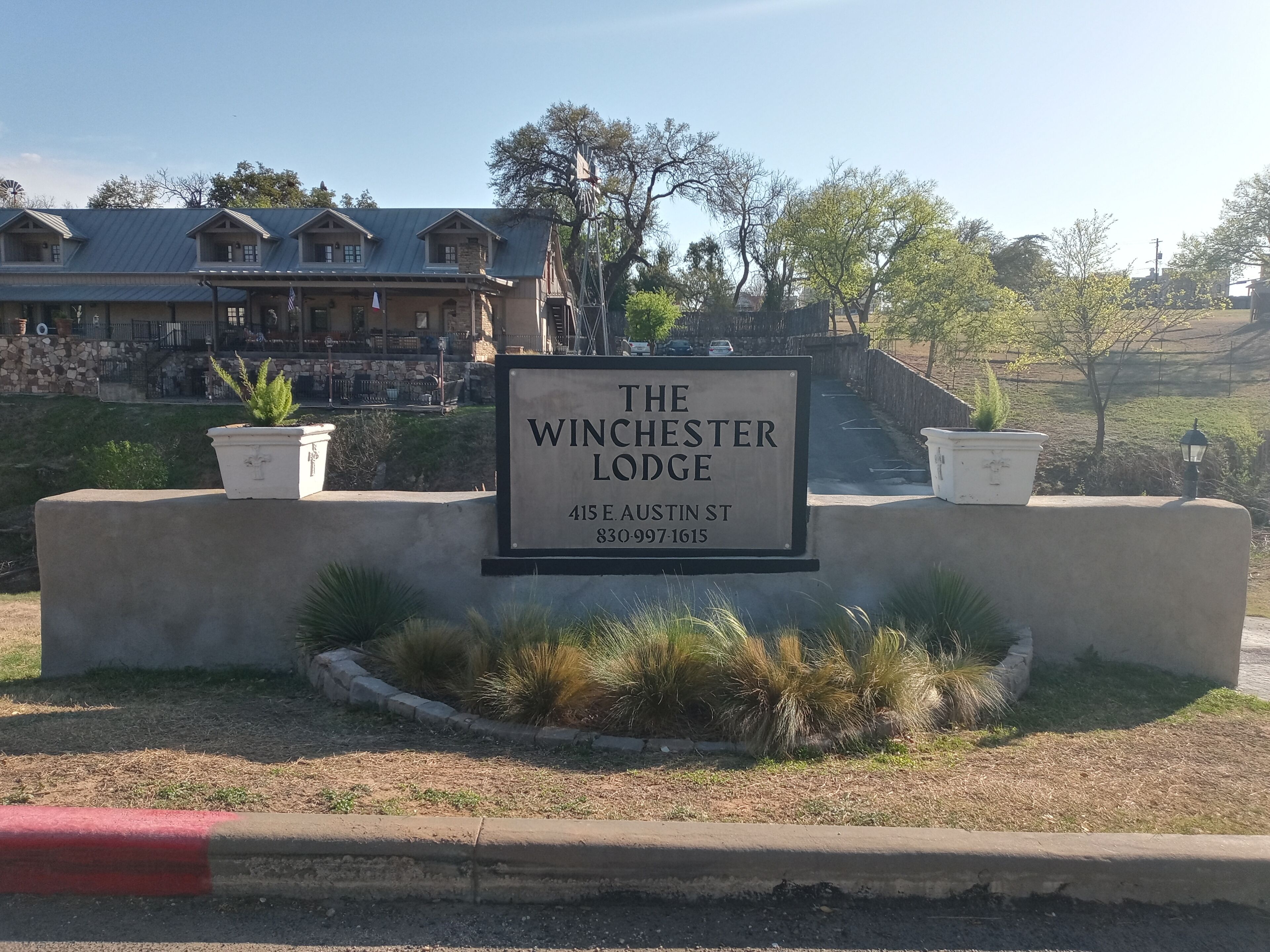 A sign for The Winchester Lodge at 415 E Austin St.