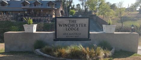 A sign for The Winchester Lodge at 415 E Austin St.