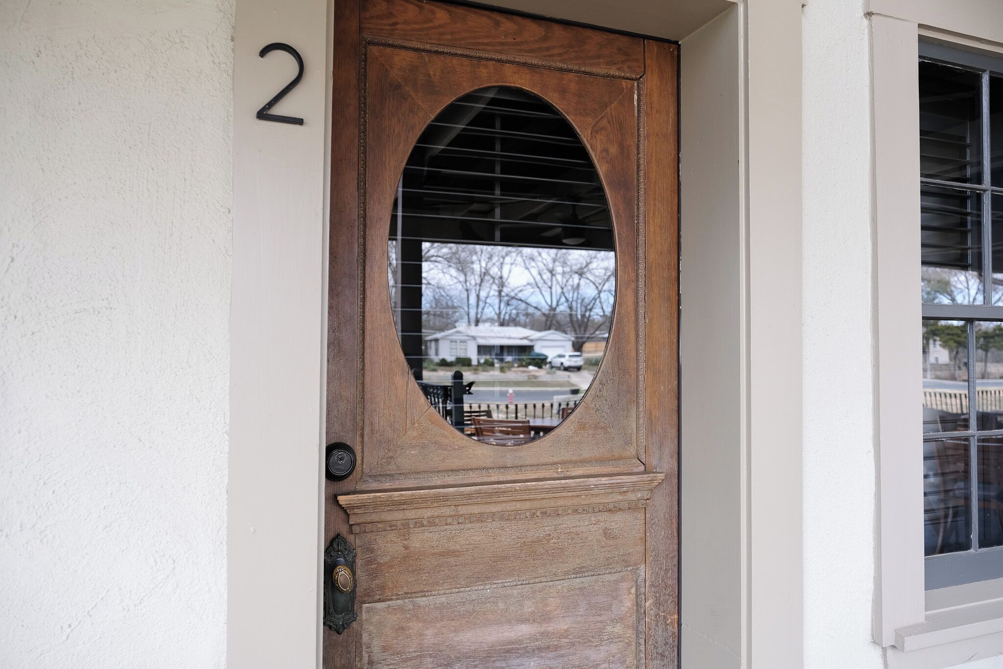 A wooden door with a number '2' on the wall beside it.