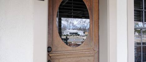 A wooden door with a number '2' on the wall beside it.