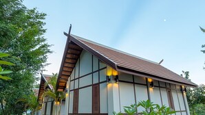 A traditional-style building with a tiled roof and large windows. - Pou Villa (Luang Namtha)