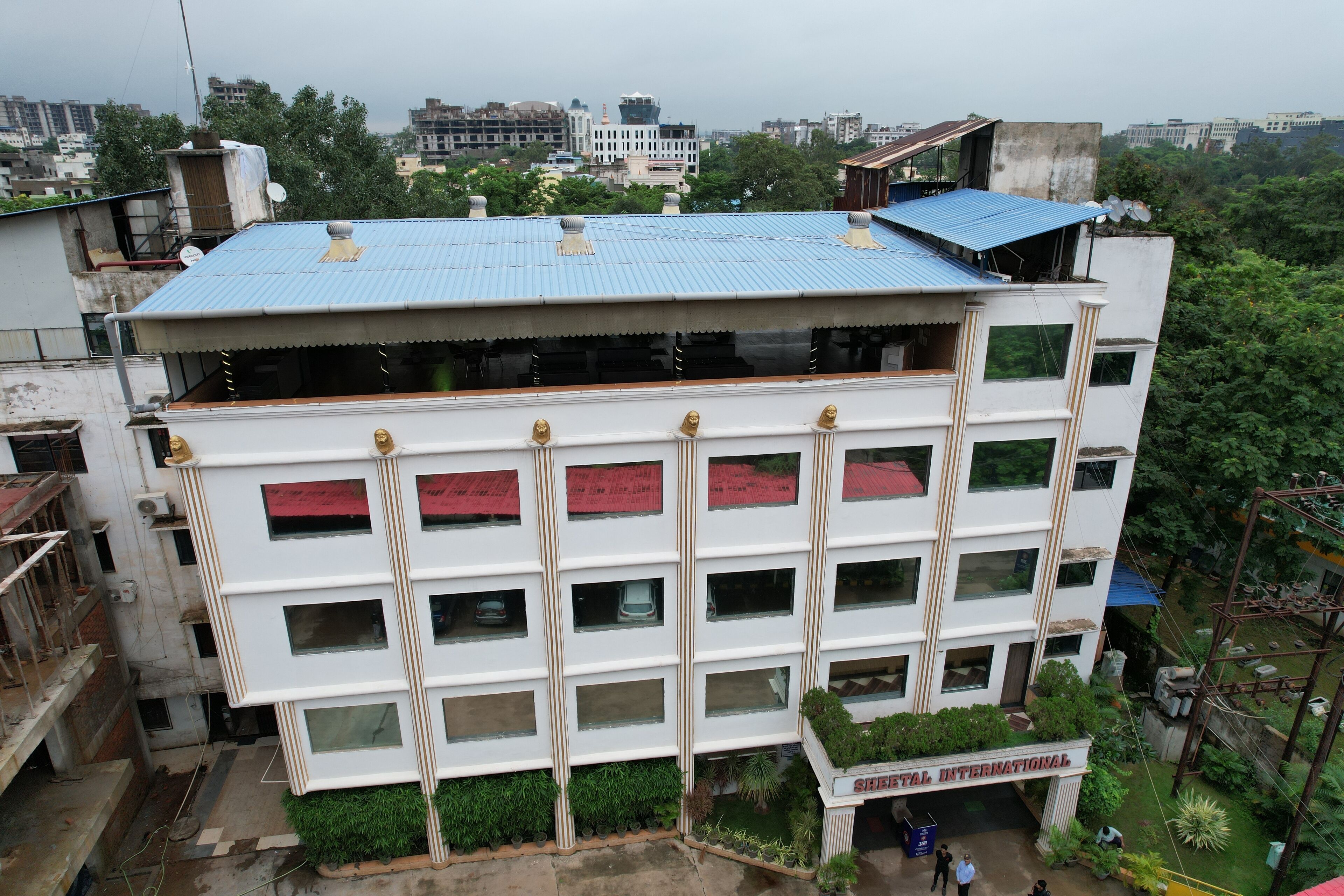 A multi-story building with a sign reading "Shital International".