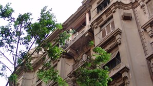 A multi-story building with ornate architectural details, including columns and decorative moldings. - Hotel Velvet 1928 (Cairo)