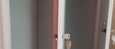 A bathroom with a shower, a toilet, and a sink.