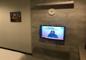 A television mounted on a wall displaying 'Kulliah Ramadan' with a clock above it. - Centrestage - Heart of Petaling Jaya 4 (Petaling Jaya)