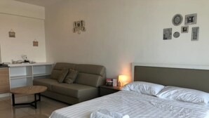 A hotel room with a bed, a sofa, a small table, and a nightstand. - Evo Soho - Bandar Baru Bangi 2 (Bandar Baru Bangi)