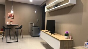 A modern kitchen with a built-in TV, a coffee machine, and a small bar area. - Pinnacle Studio - Heart of Petaling Jaya (Petaling Jaya)