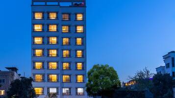 Stunning hotel building with modern design, surrounded by lush greenery and natural beauty.