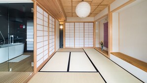 A traditional Japanese room with tatami flooring, sliding doors, and a modern bathroom. - Lica's Room (Kyoto)