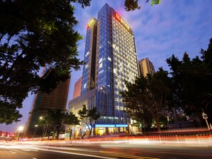 A high-rise hotel with multiple floors, large windows, and a prominent entrance. - Royal Star Apartment Central City Branch (Guangzhou)