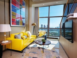 Deluxe Duplex | Living area | 48-inch flat-screen TV with cable channels, TV