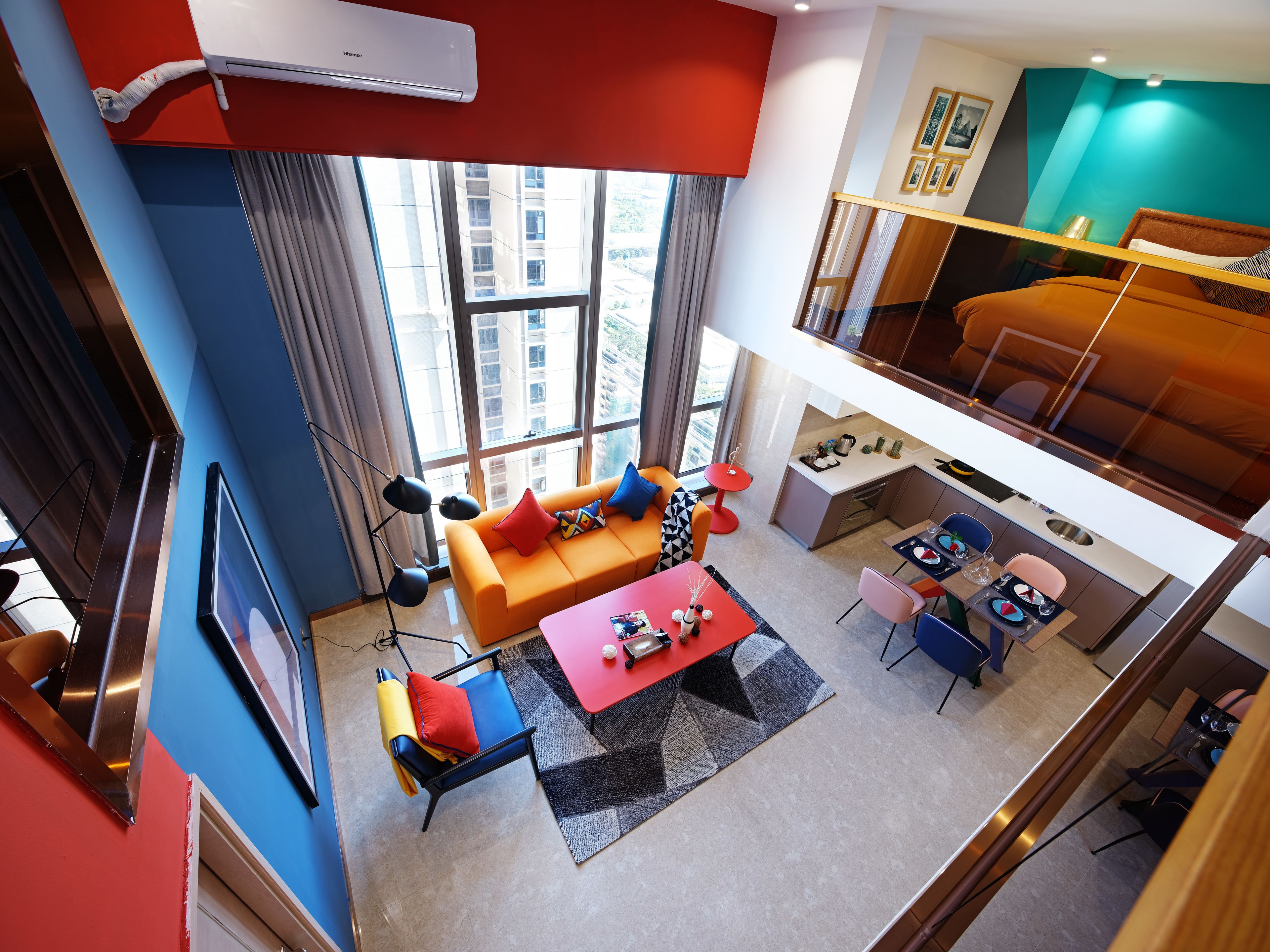 A modern living room with a sofa, coffee table, and dining area.