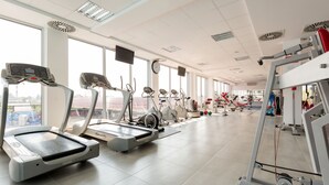 A gym with treadmills, stationary bikes, and weight machines. - Flamingo resort (Belgrade)