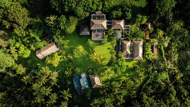 An aerial view of a resort with multiple buildings, a swimming pool, and lush greenery. - Villa Palem (Selemadeg)