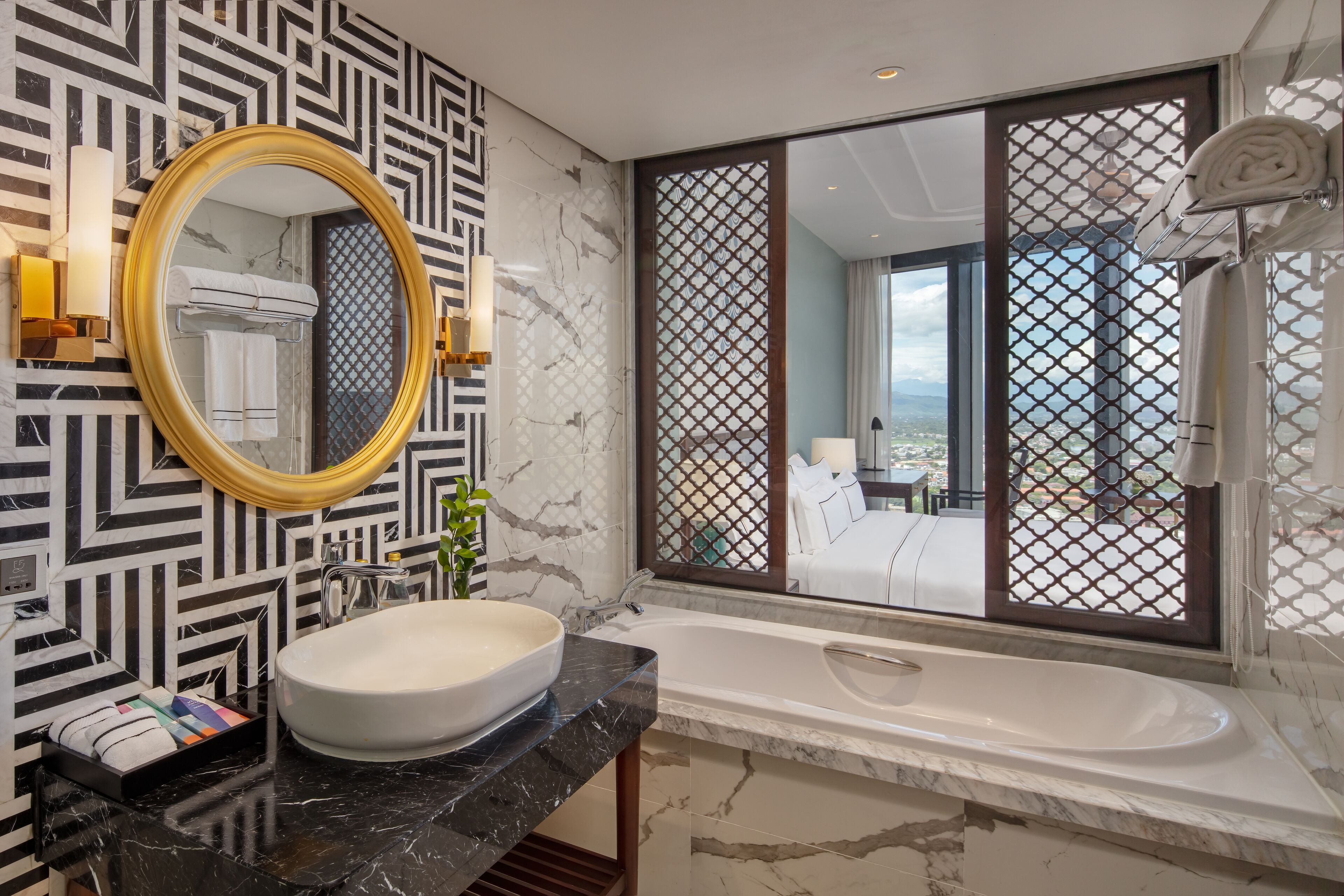 A modern bathroom with a large mirror, a white sink, and a bathtub.