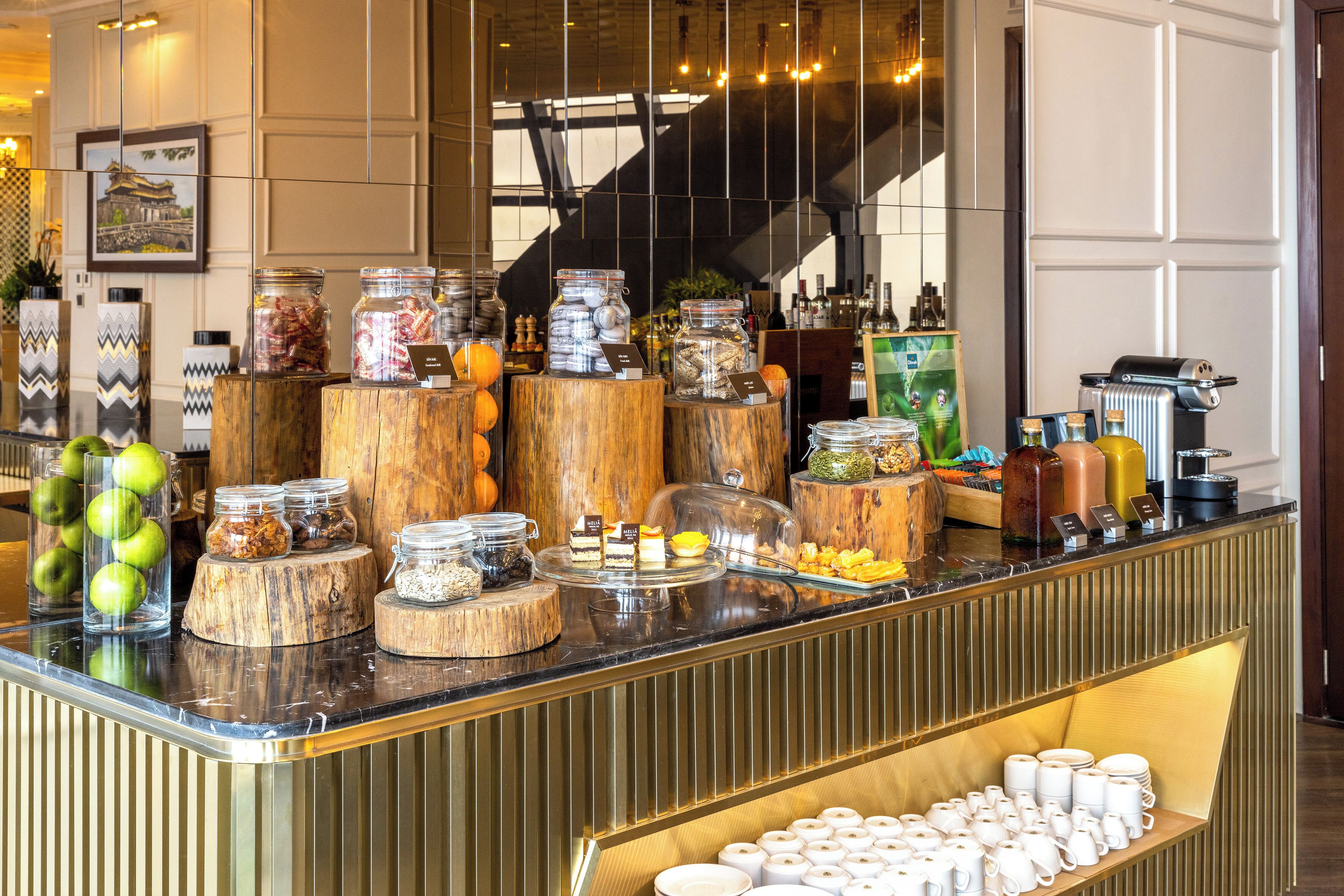 A buffet counter with various food items and condiments.