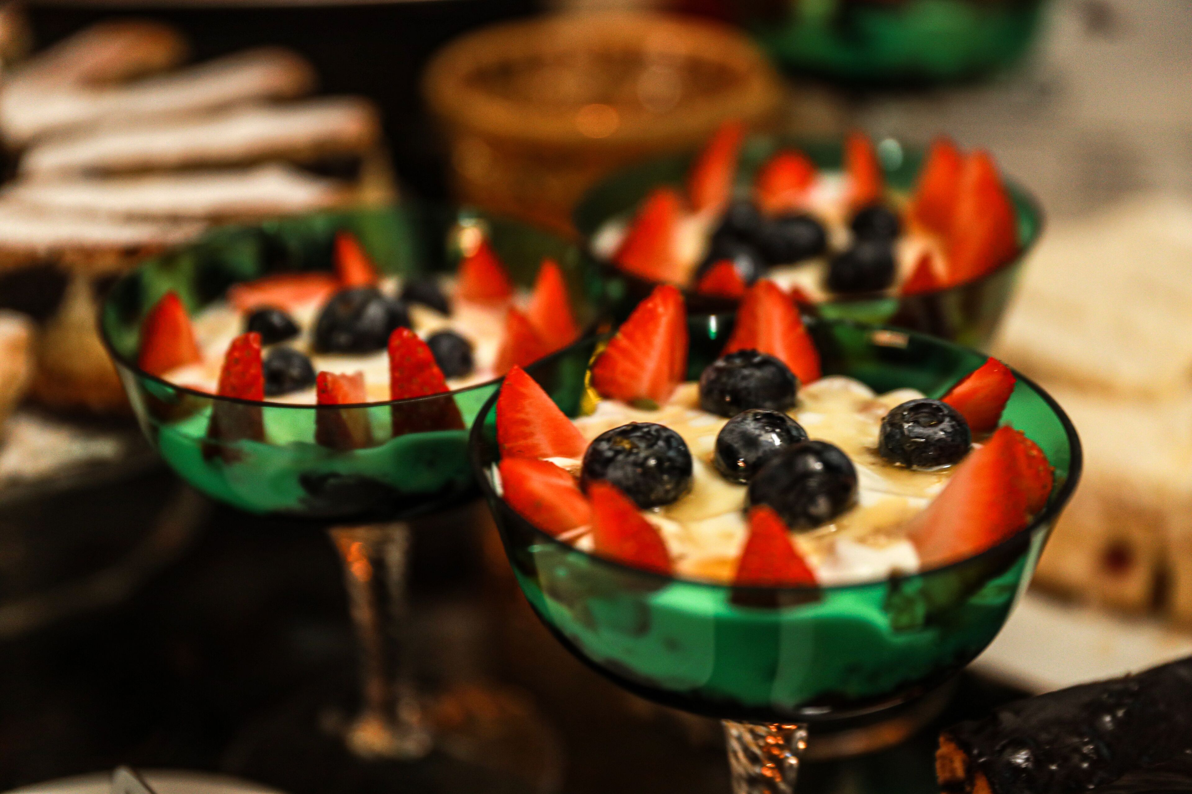 A close-up of a dessert dish with strawberries and blueberries.