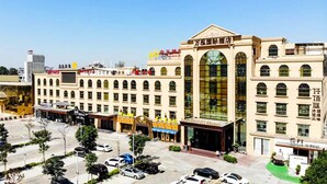 A large hotel with a prominent entrance, multiple floors, and a parking lot in front. - VANHONG Hotel (Guangzhou)