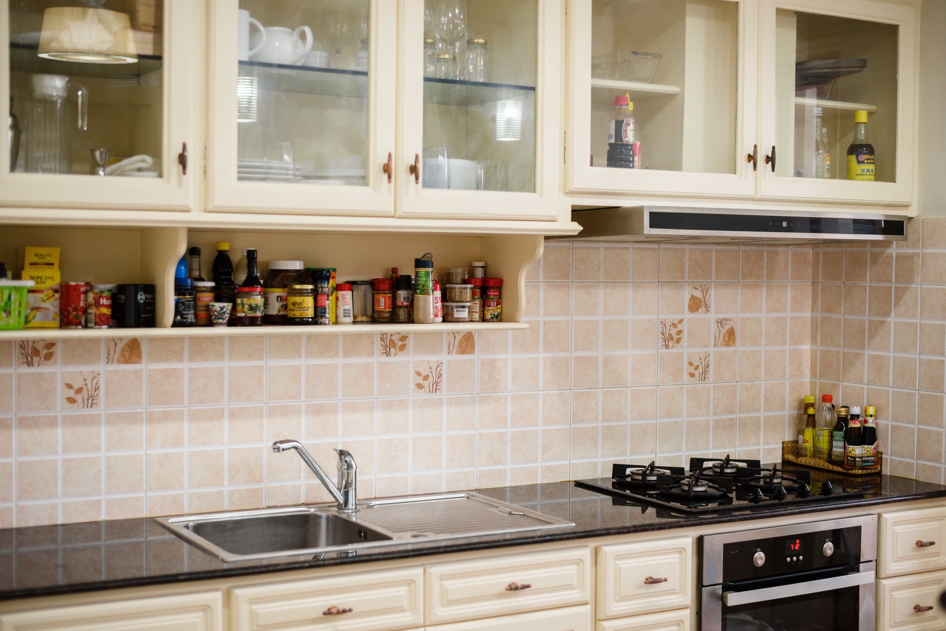 Une cuisine équipée d’un évier, d’une cuisinière et de placards.