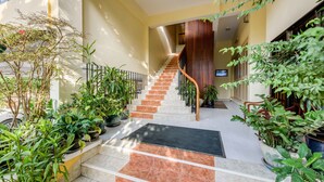 Una escalera con barandilla de madera que lleva a una plataforma donde hay un televisor.
