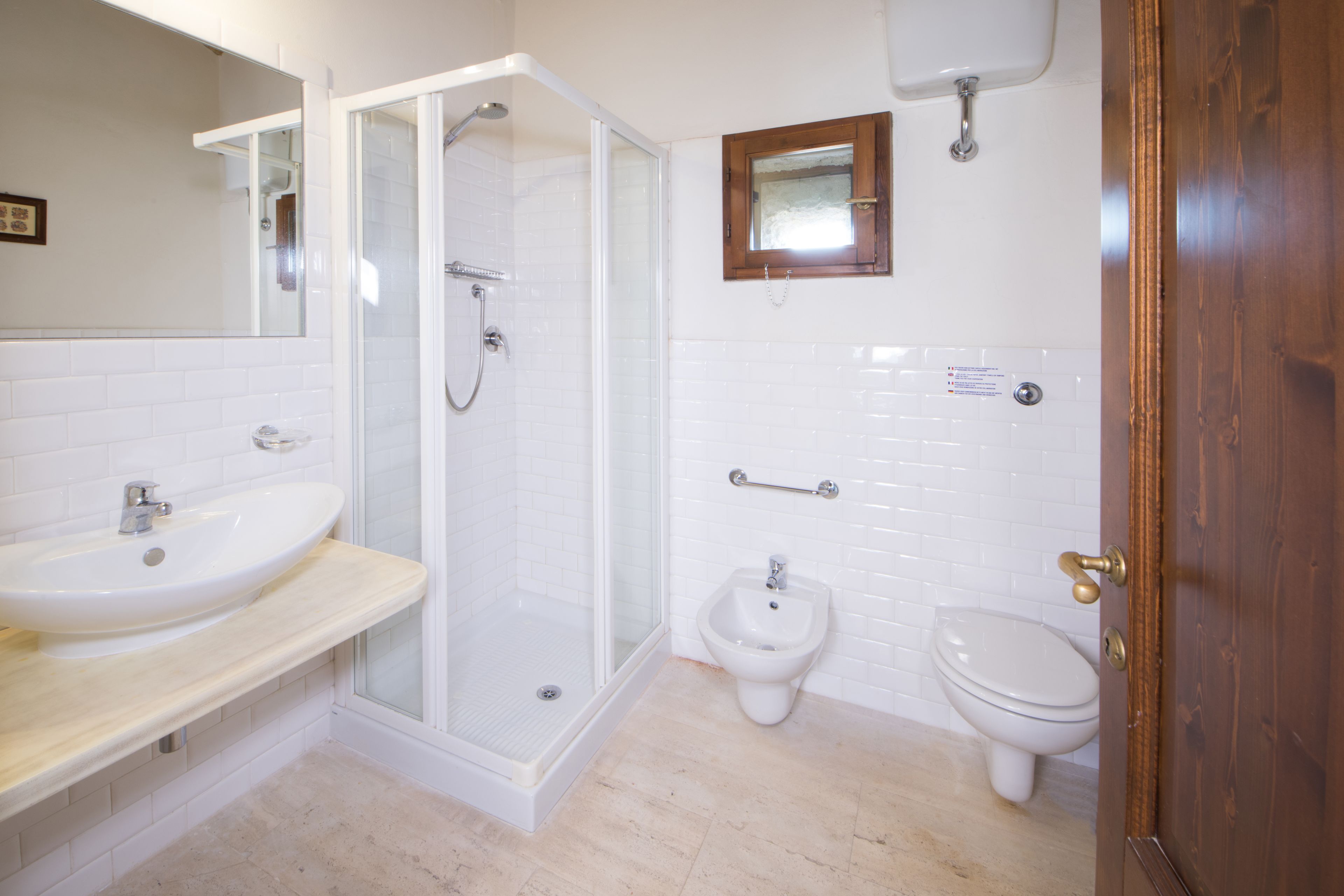 Une salle de bain équipée d’une douche, d’un lavabo, d’un bidet et de toilettes.
