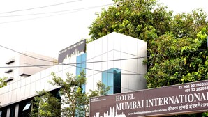 A sign for Hotel Mumbai International with a city skyline silhouette. - Hotel Mumbai International (Mumbai)
