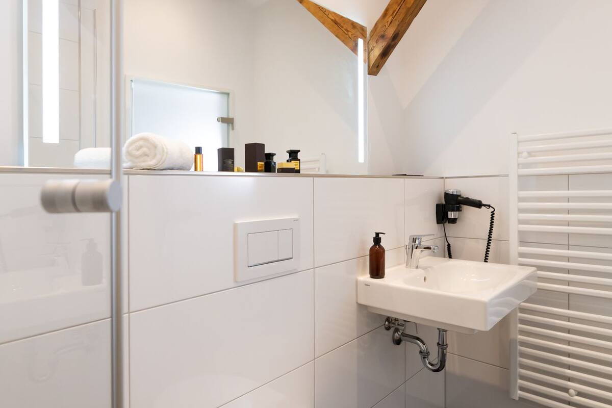 superior double room | bathroom | shower, rainfall showerhead, hair dryer, towels