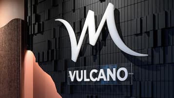 A modern building facade with a prominent 'Vulcano' sign.