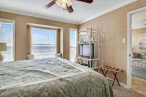 Relax in this inviting room with a large bed, TV, and balcony offering ocean views.