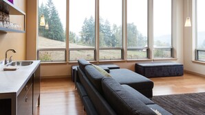 A modern kitchen with a built-in sink and a dining area with a bench. - Mountain House 4 Bedroom Home by RedAwning (Parkdale)