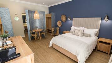 A bedroom with a bed, bedside tables, a desk, and a chair.
