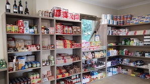 A well-stocked grocery store with various food items, beverages, and household products.