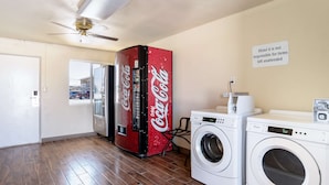 A room with a washing machine, a dryer, and a Coca-Cola refrigerator. - Motel 6 Odessa, TX - 2nd Street (Odessa)