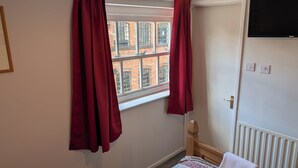A room with a window, a radiator, and a bed. - The Bull (Birmingham)