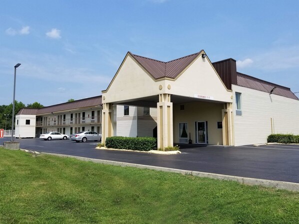 Simple, functional design with a covered entrance and parking spaces.