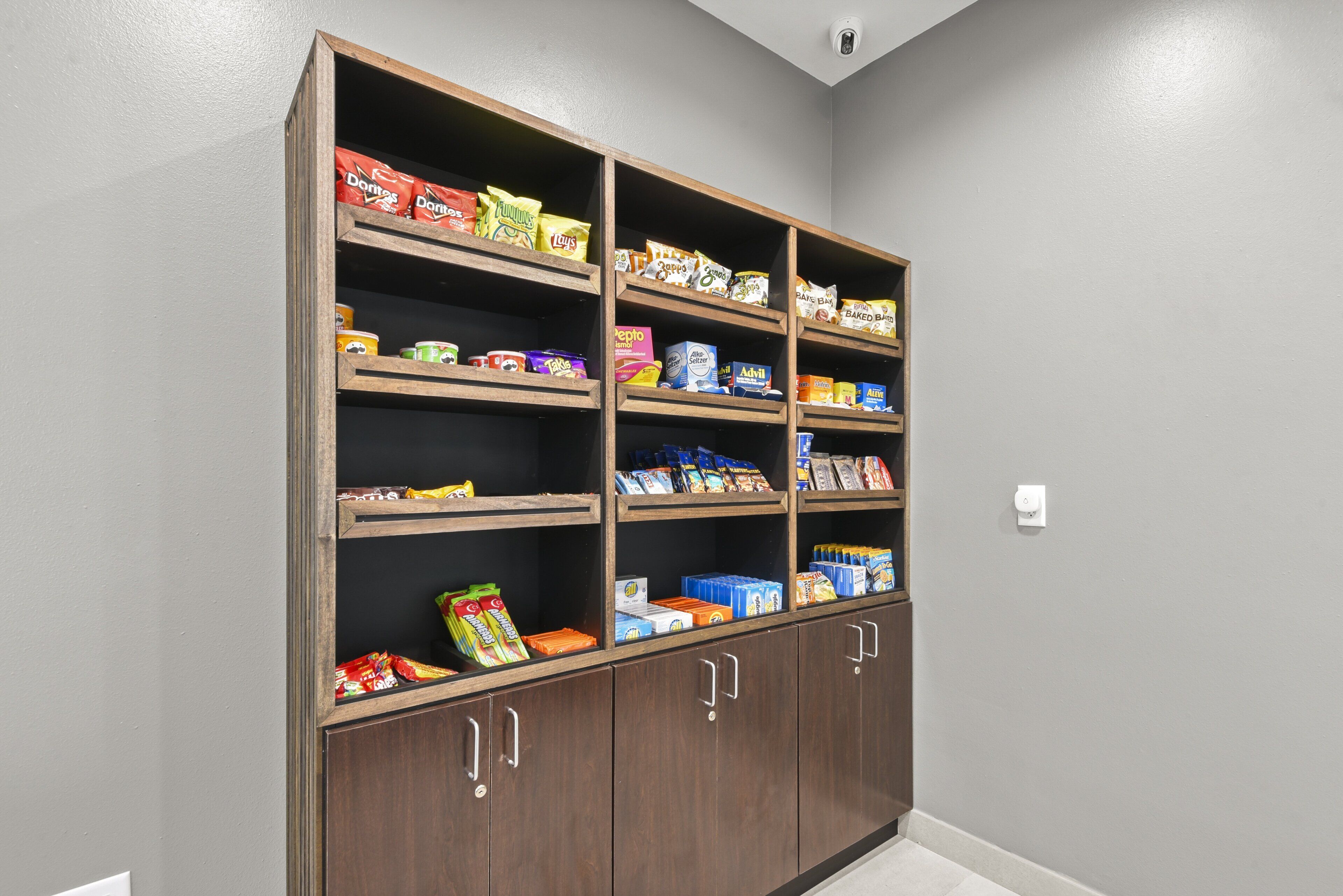 A pantry with multiple shelves stocked with various food items.